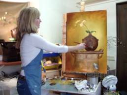 artist painting a still life flower artwork demo