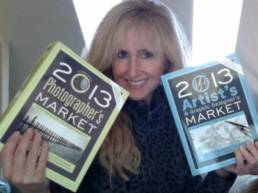 lori mcnee holding artists & graphic designer's market and photographer's market books