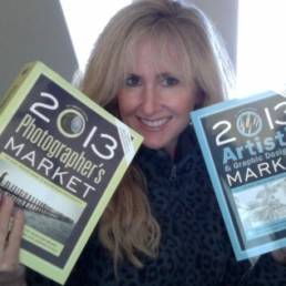 lori mcnee holding artists & graphic designer's market and photographer's market books