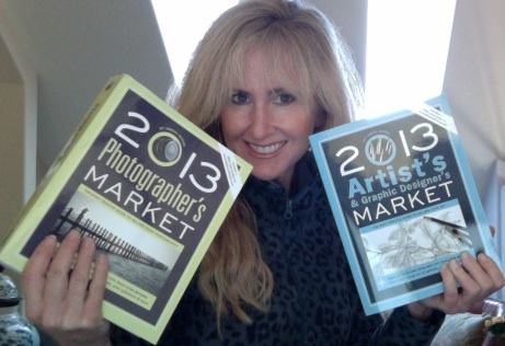 lori mcnee holding artists & graphic designer's market and photographer's market books